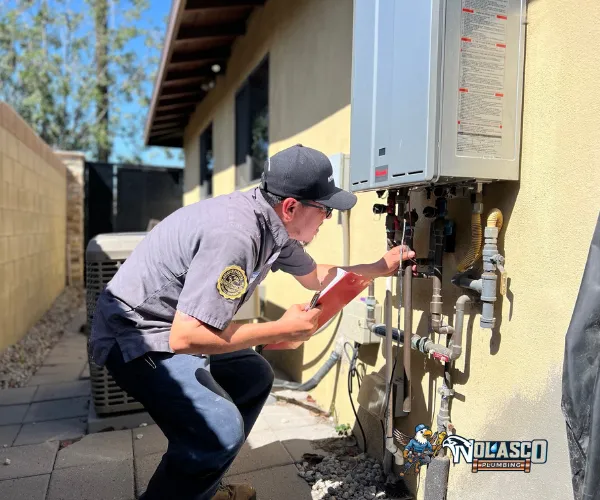 Corroded copper pipe joint with heavy mineral deposits and green oxidation.